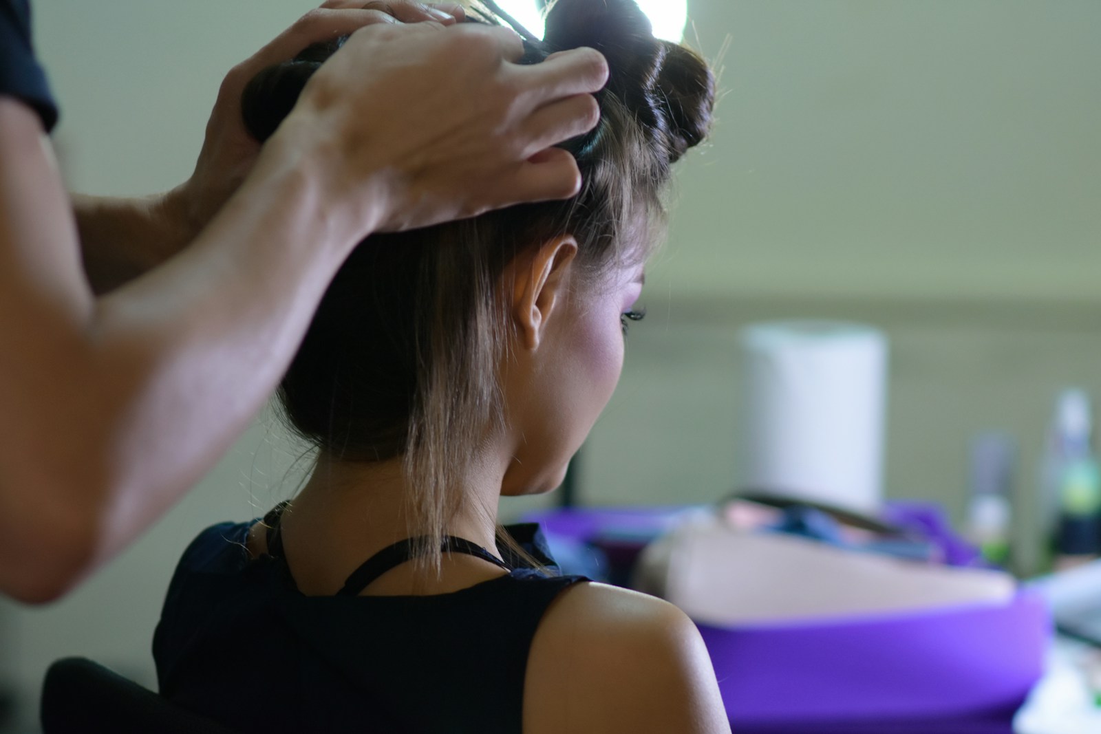 woman in black tank top holding her hair